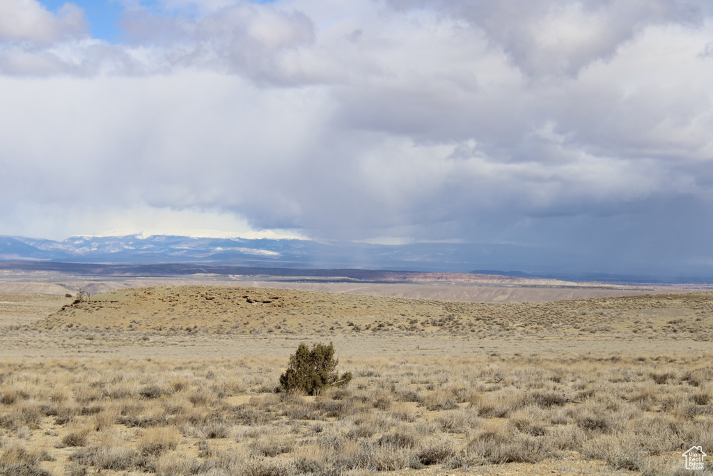 View of mountain backdrop with rural landscape and a desert landscape