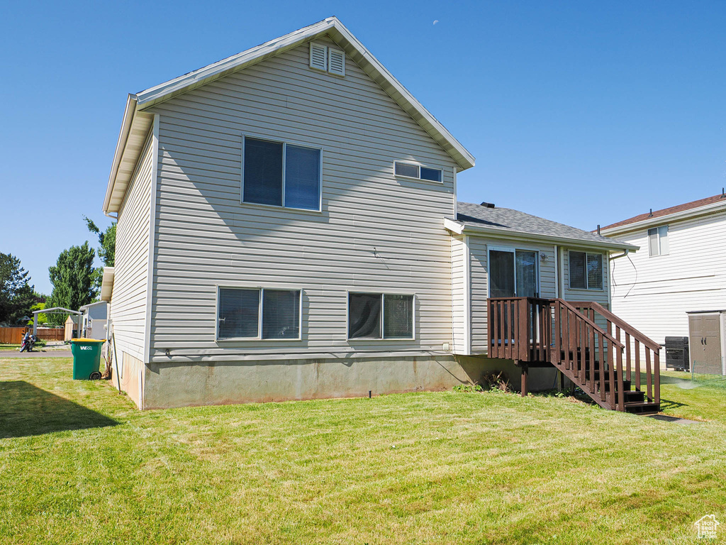 Back of house with a yard