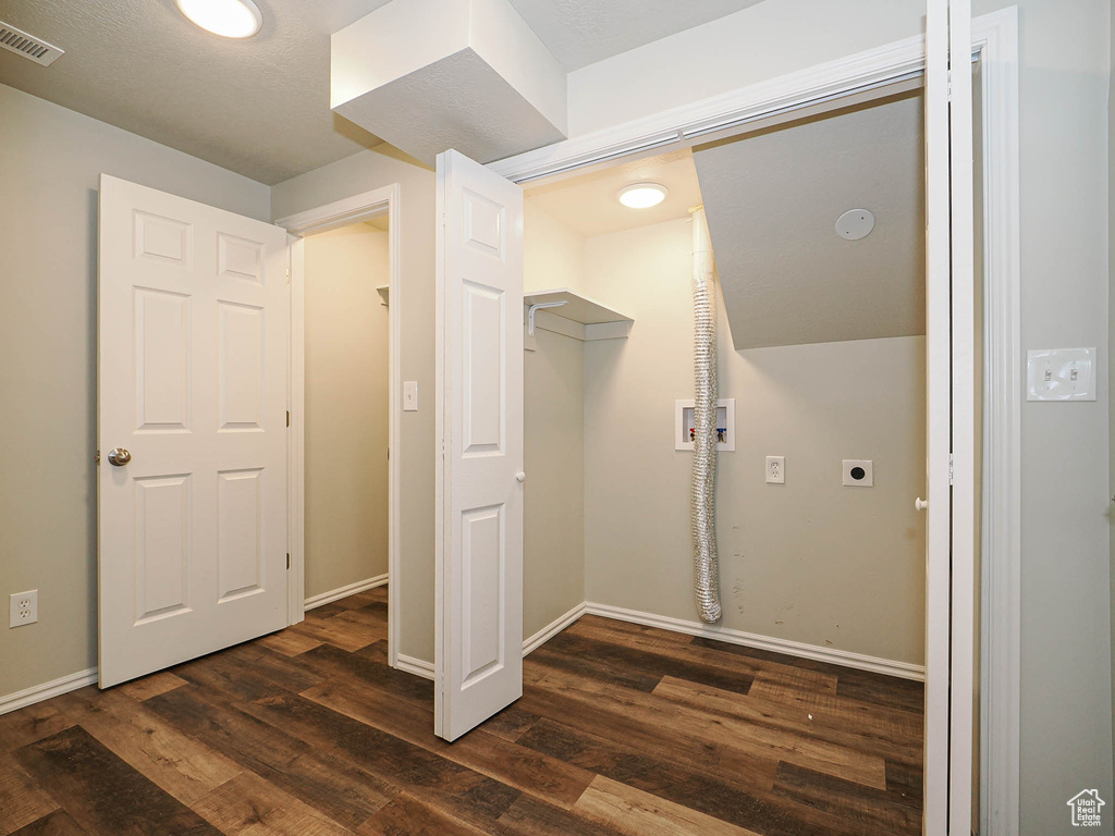 Laundry room with electric dryer hookup, dark wood-type flooring, and washer hookup