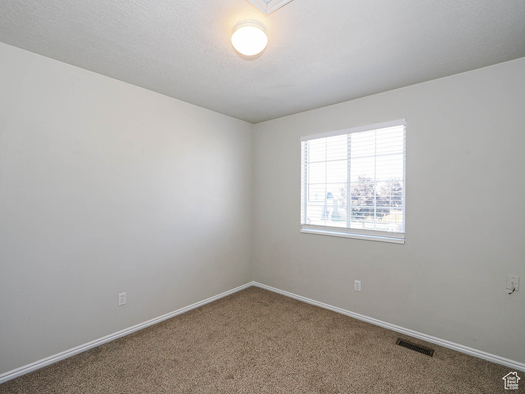 Unfurnished room featuring carpet flooring and baseboards