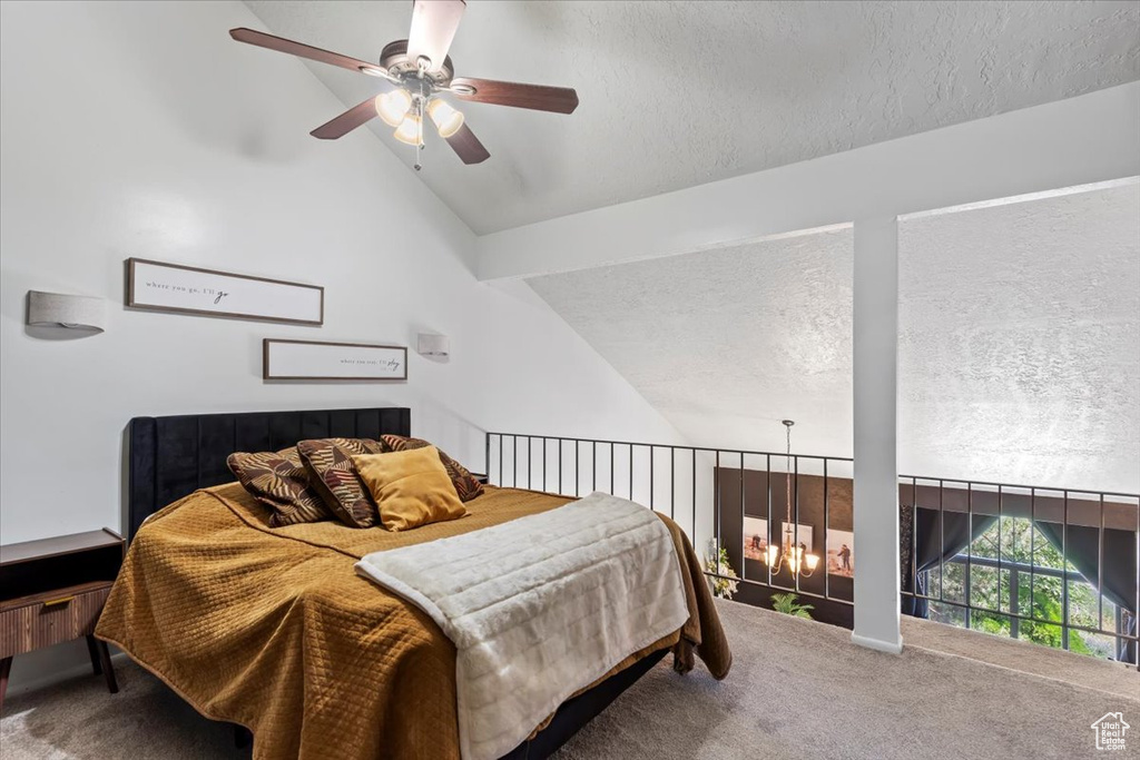 Bedroom featuring carpet, vaulted ceiling, a textured ceiling, and a ceiling fan
