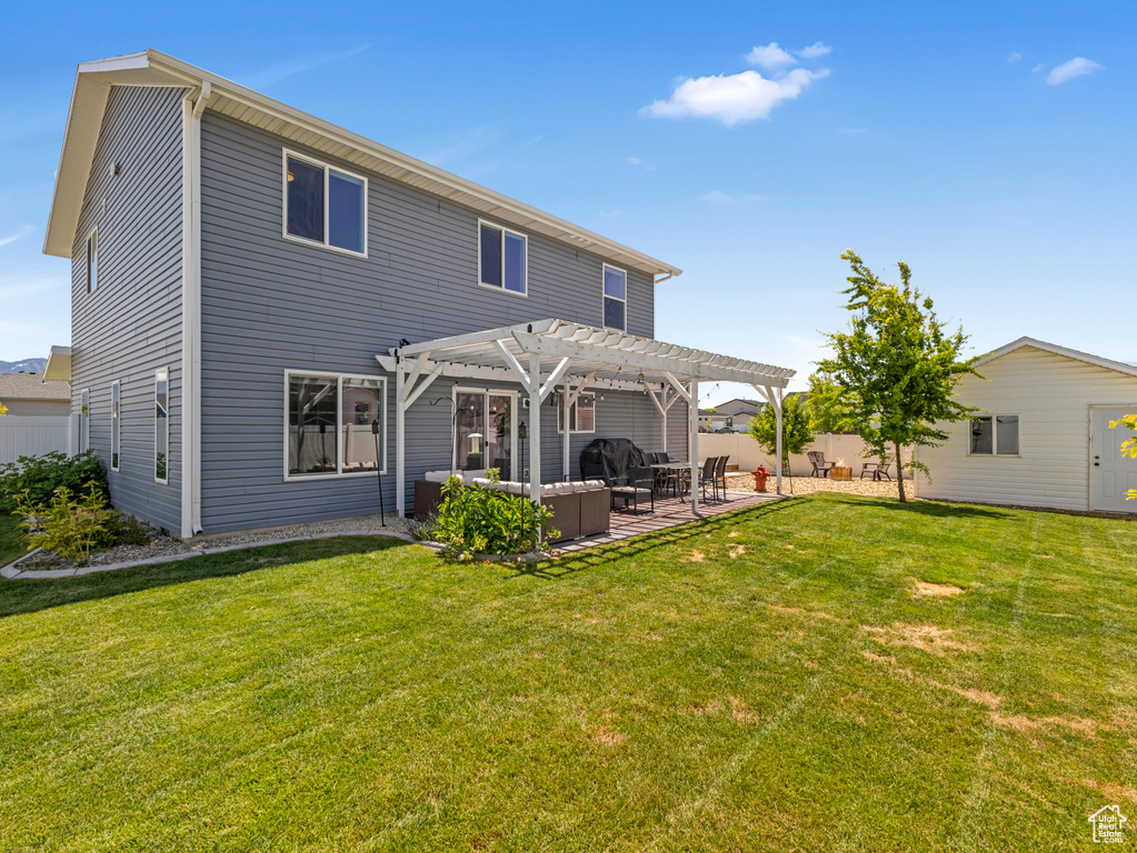 Back of house with a pergola and a patio