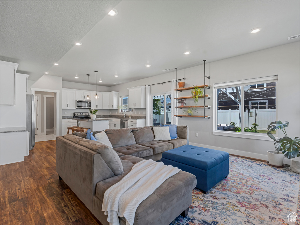 Living room featuring dark wood finished floors and recessed lighting