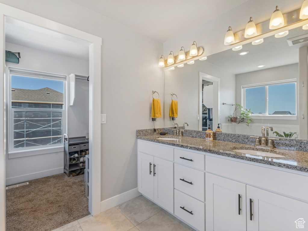 Full bathroom with double vanity and tile patterned flooring
