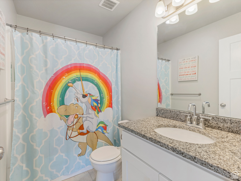 Full bath featuring vanity and tile patterned floors