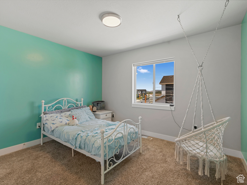 Carpeted bedroom with baseboards