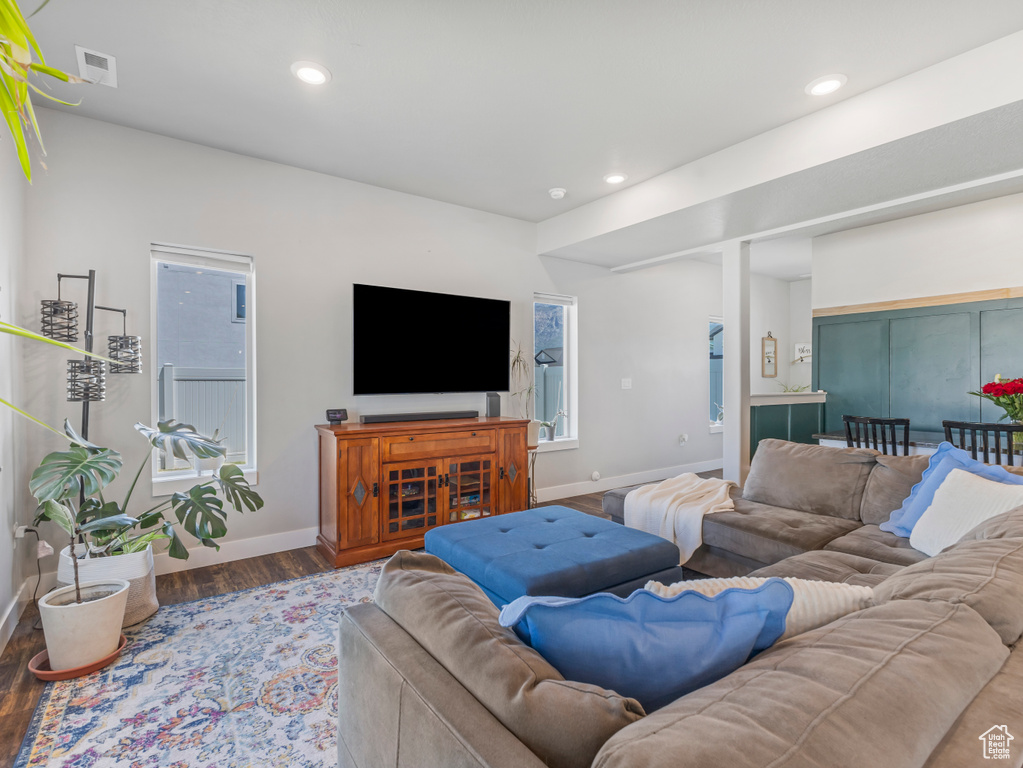 Living area with wood finished floors, recessed lighting, and plenty of natural light