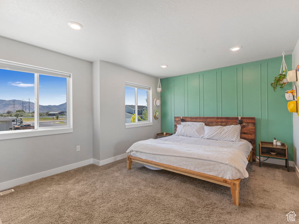 Carpeted bedroom featuring a mountain view and recessed lighting