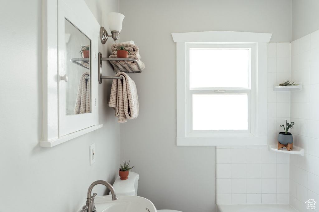 Full bath featuring toilet and a sink