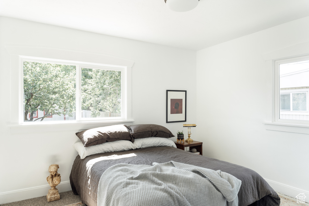Carpeted bedroom featuring baseboards