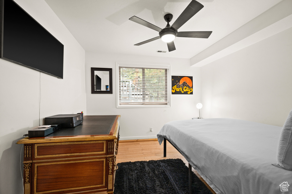 Bedroom with wood finished floors and ceiling fan