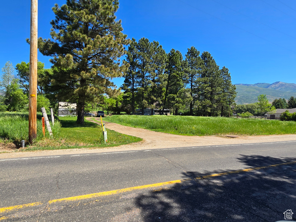 View of asphalt street featuring a mountain view