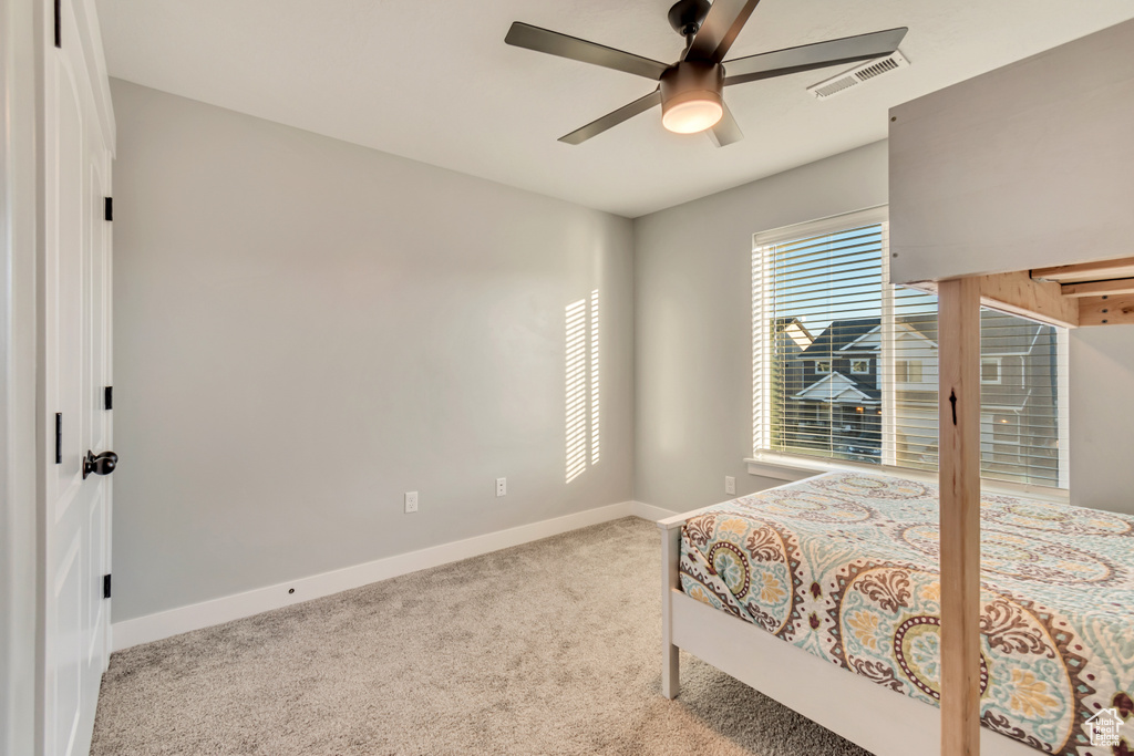 Bedroom with carpet floors and a ceiling fan