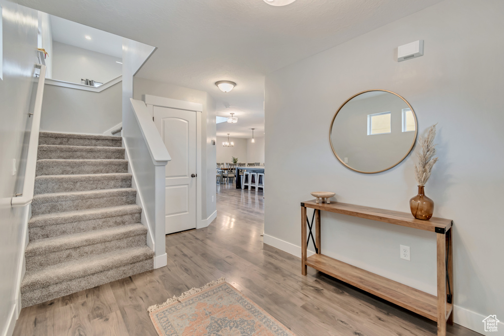 Staircase featuring wood finished floors and baseboards