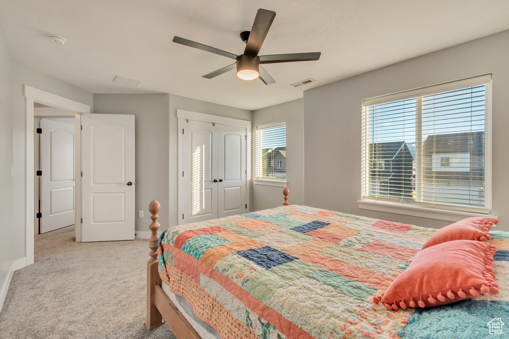 Bedroom with carpet, a ceiling fan, and a closet