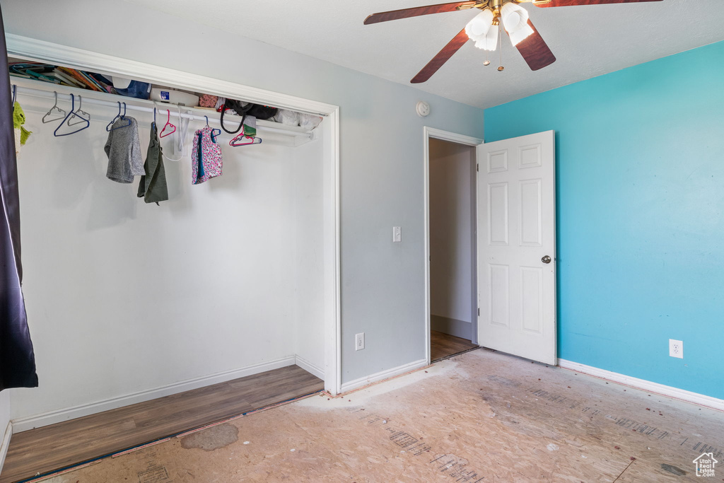 Unfurnished bedroom with a ceiling fan and wood finished floors