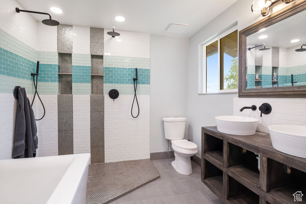 Full bathroom with walk in shower, tile patterned floors, and double vanity