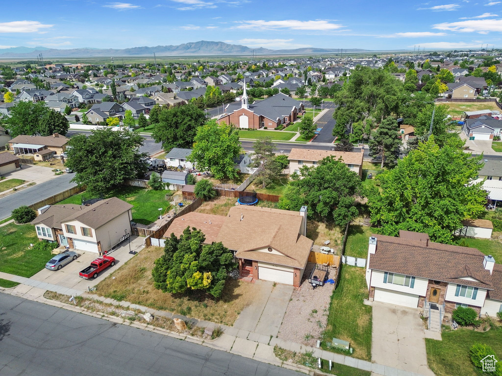Aerial perspective of suburban area featuring a mountain backdrop