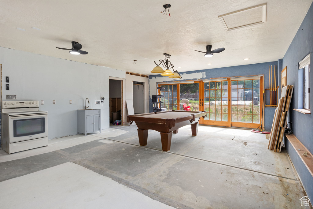 Recreation room with pool table and unfinished concrete floors