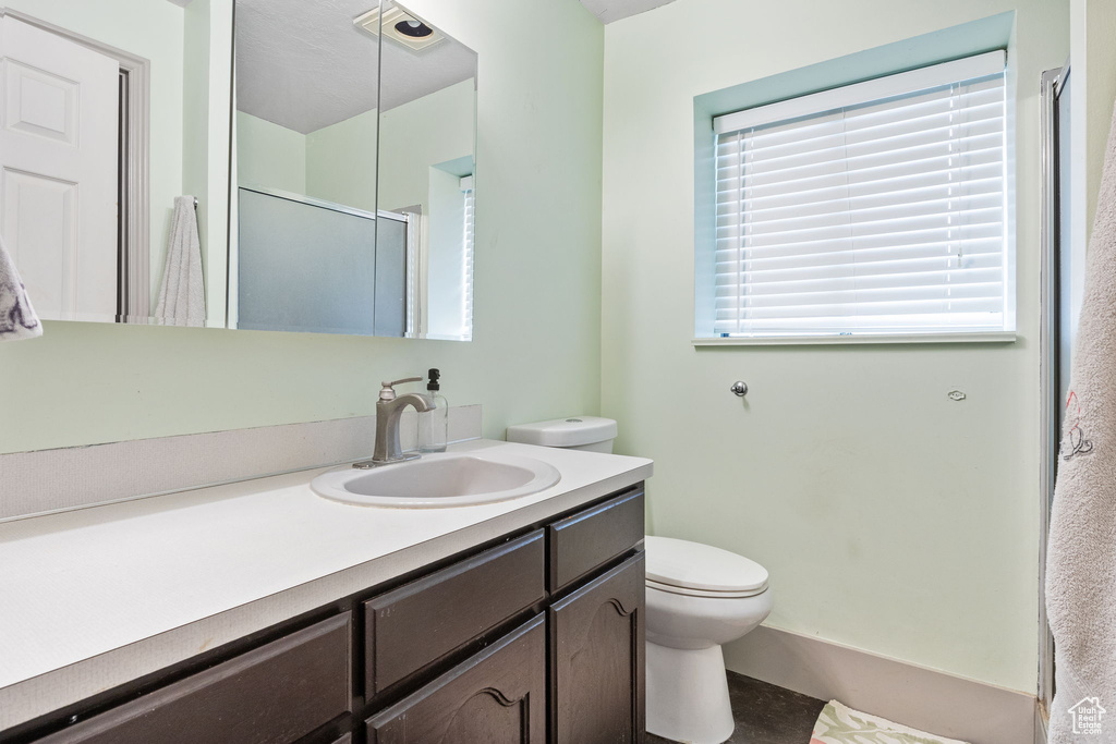 Full bath featuring vanity and a shower with shower door