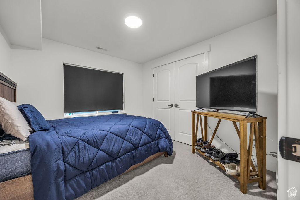 Bedroom featuring carpet floors and a closet