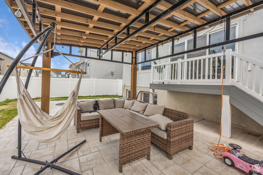 Fenced backyard featuring a patio and an outdoor hangout area