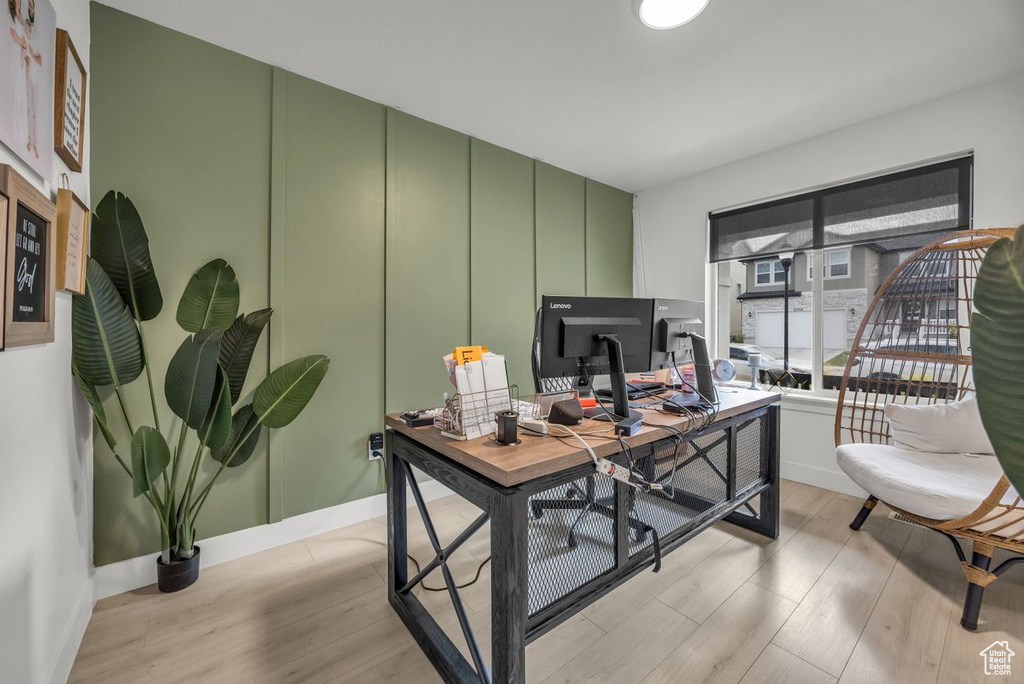 Office area with light wood-style floors and baseboards