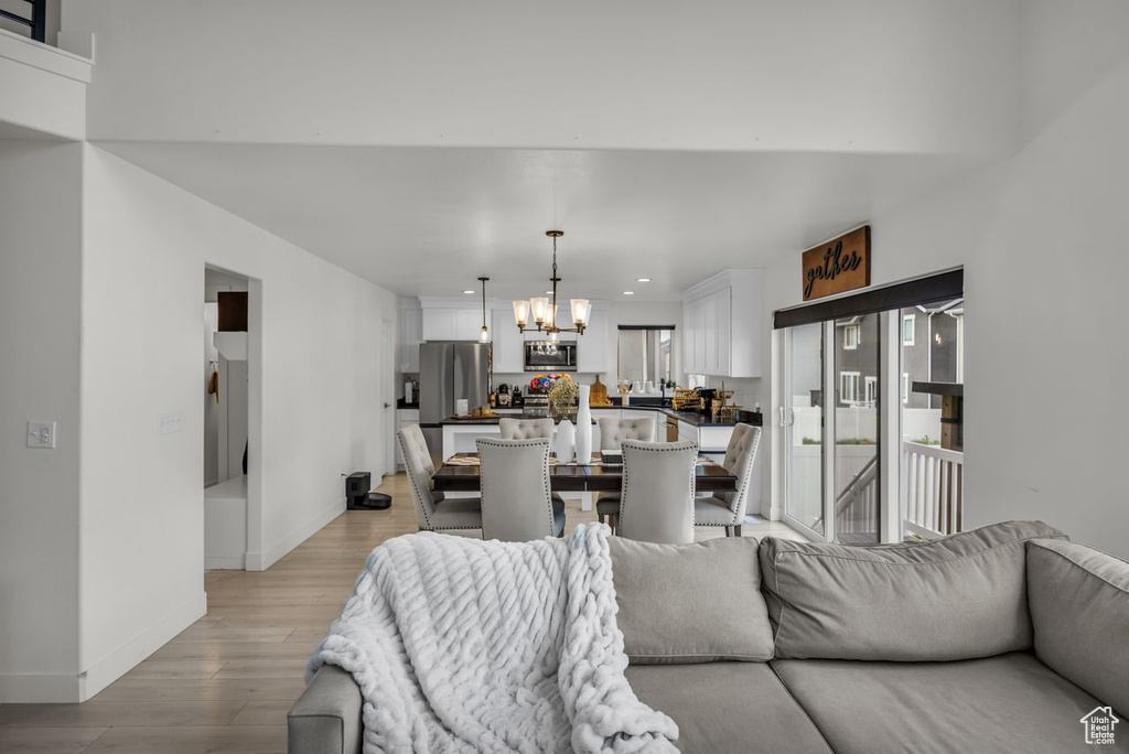 Living room featuring a chandelier, light wood finished floors, and recessed lighting