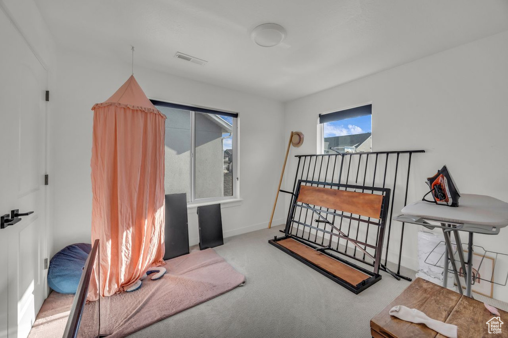 Bedroom featuring carpet flooring and baseboards