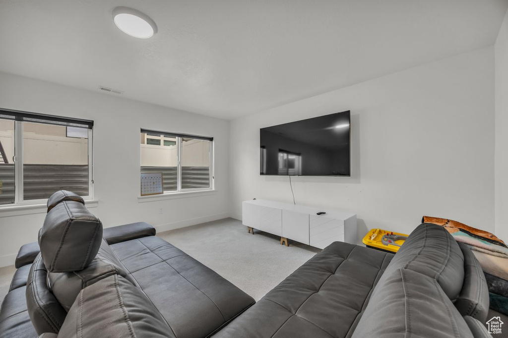 Carpeted living area with baseboards