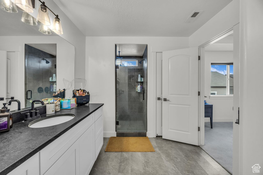Bathroom with vanity and a shower stall