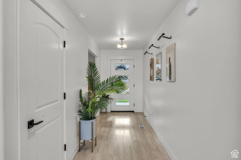 Corridor with baseboards and light wood-style floors