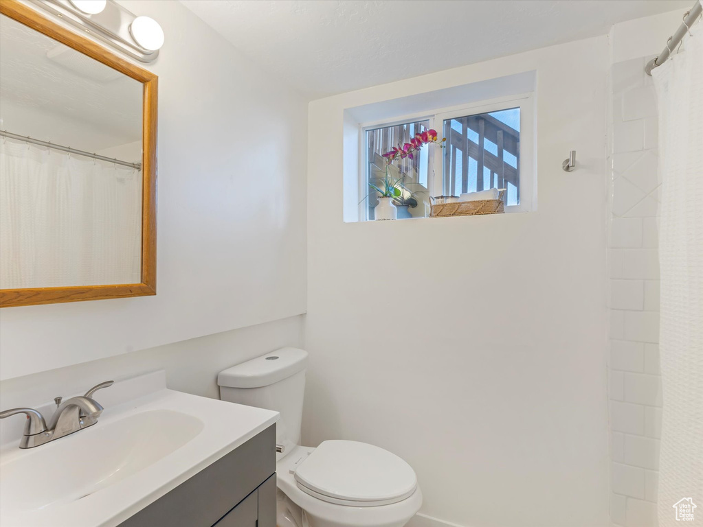 Full bathroom with vanity and a shower with curtain
