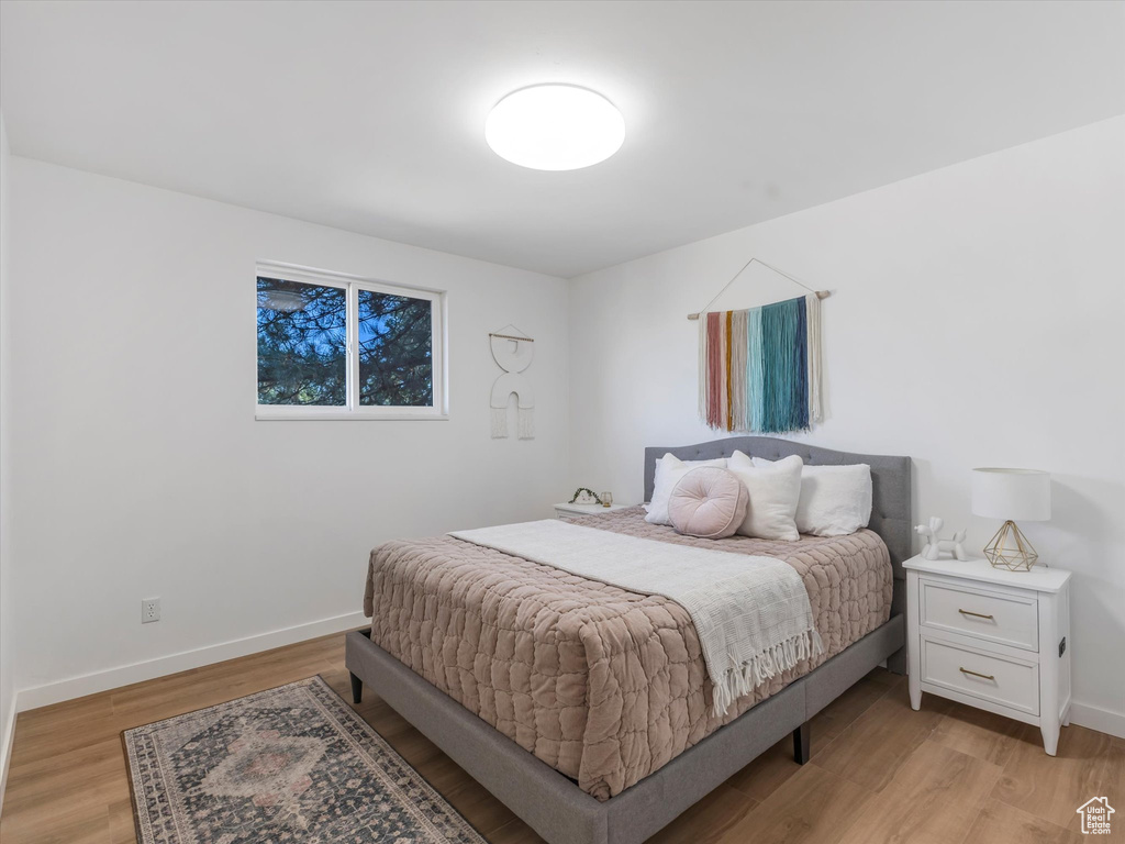 Bedroom featuring light wood-style flooring and baseboards