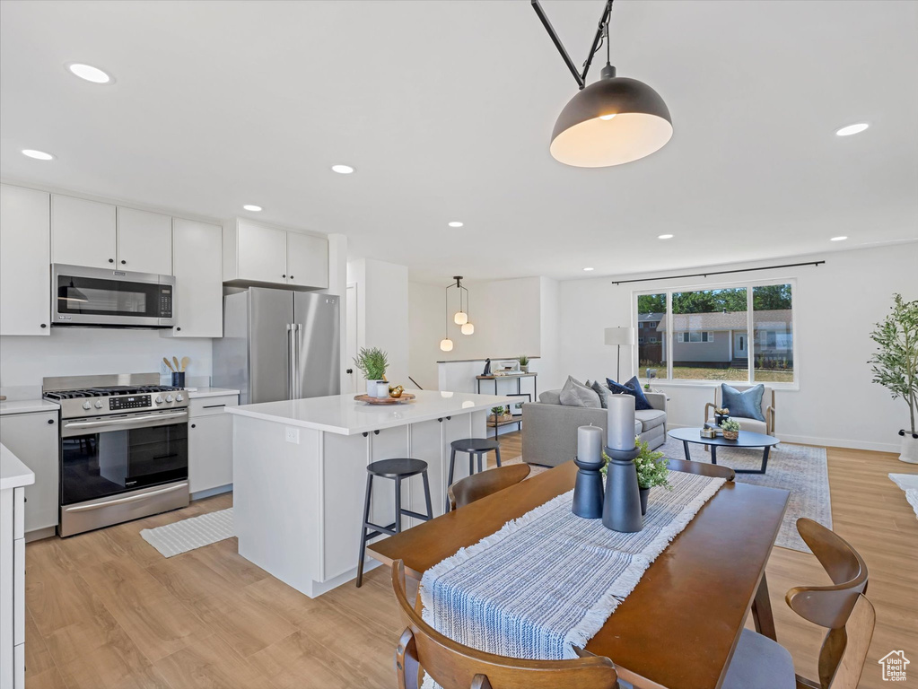 Dining space featuring light wood finished floors and recessed lighting