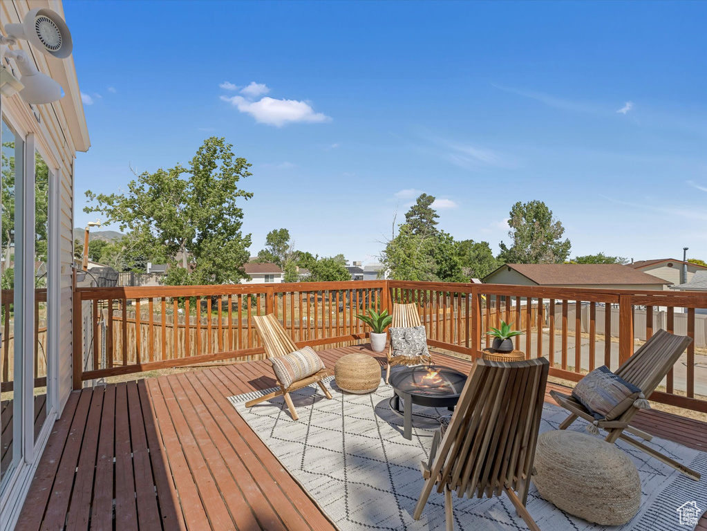 Wooden deck featuring an outdoor fire pit