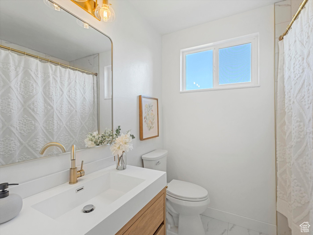 Bathroom with vanity and marble finish flooring