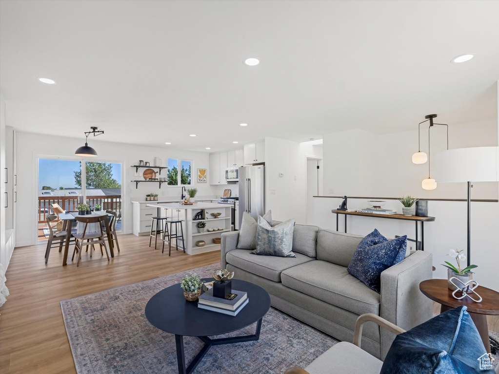 Living area featuring light wood finished floors and recessed lighting