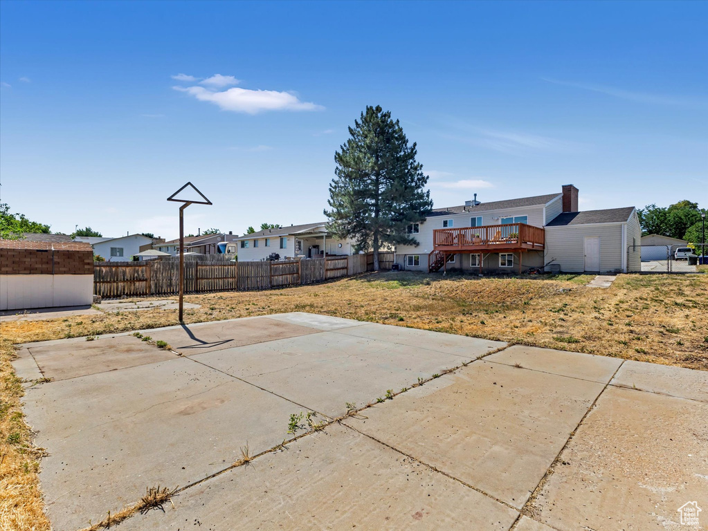 View of patio featuring a shed and a wooden deck