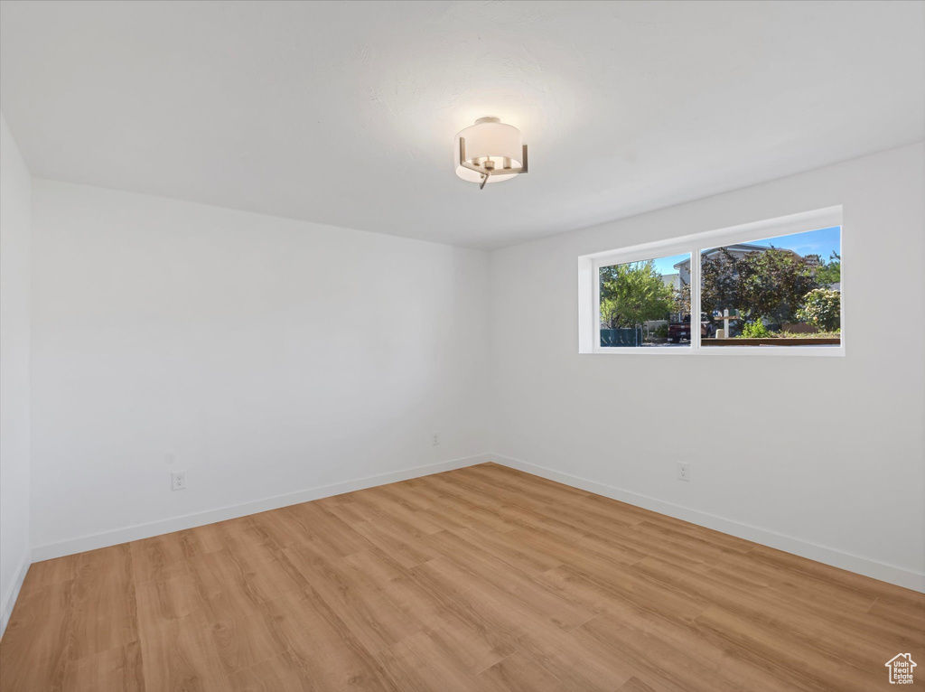 Unfurnished room featuring light wood-type flooring