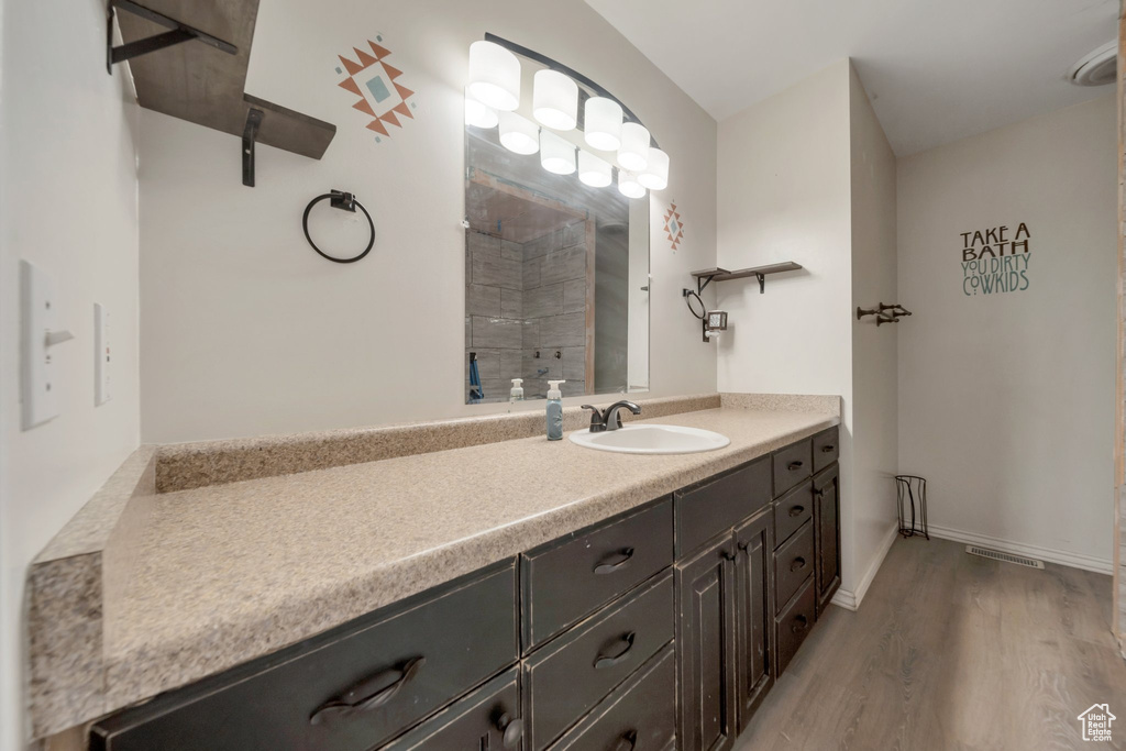 Full bath featuring vanity and wood finished floors