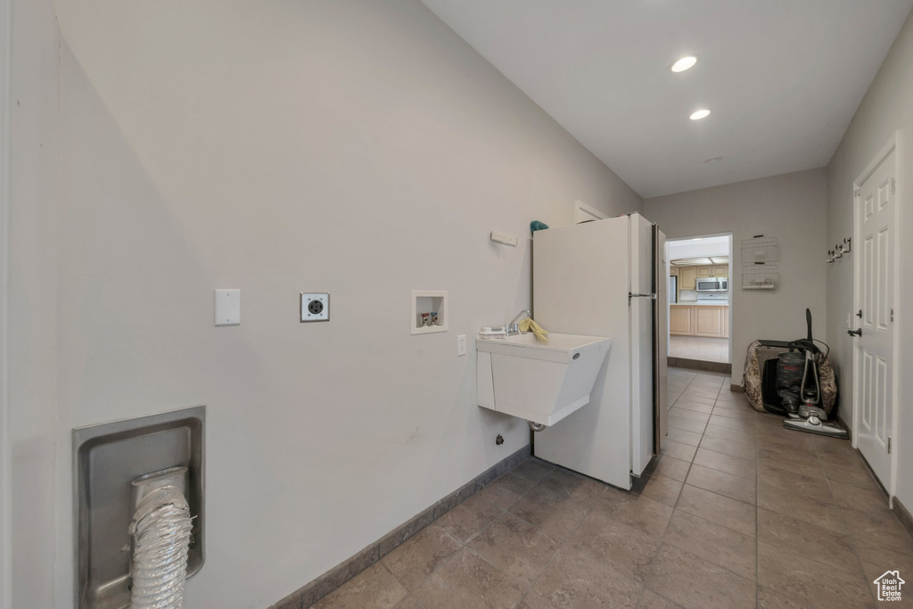 Laundry room with hookup for an electric dryer, hookup for a washing machine, and recessed lighting