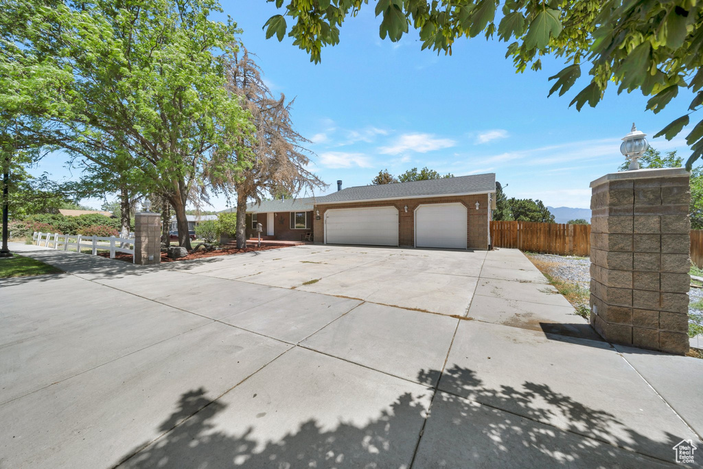 View of front facade with concrete driveway and an attached garage