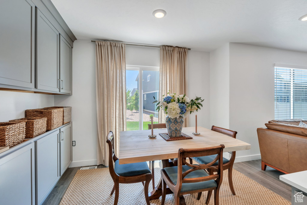 Dining area featuring light wood finished floors and recessed lighting