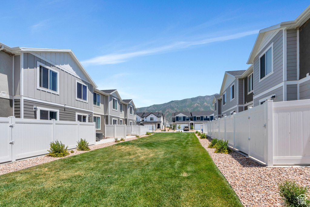 Fenced backyard with a residential view and a mountain view
