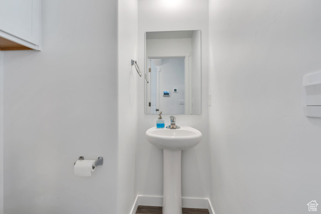 Bathroom featuring a sink and baseboards