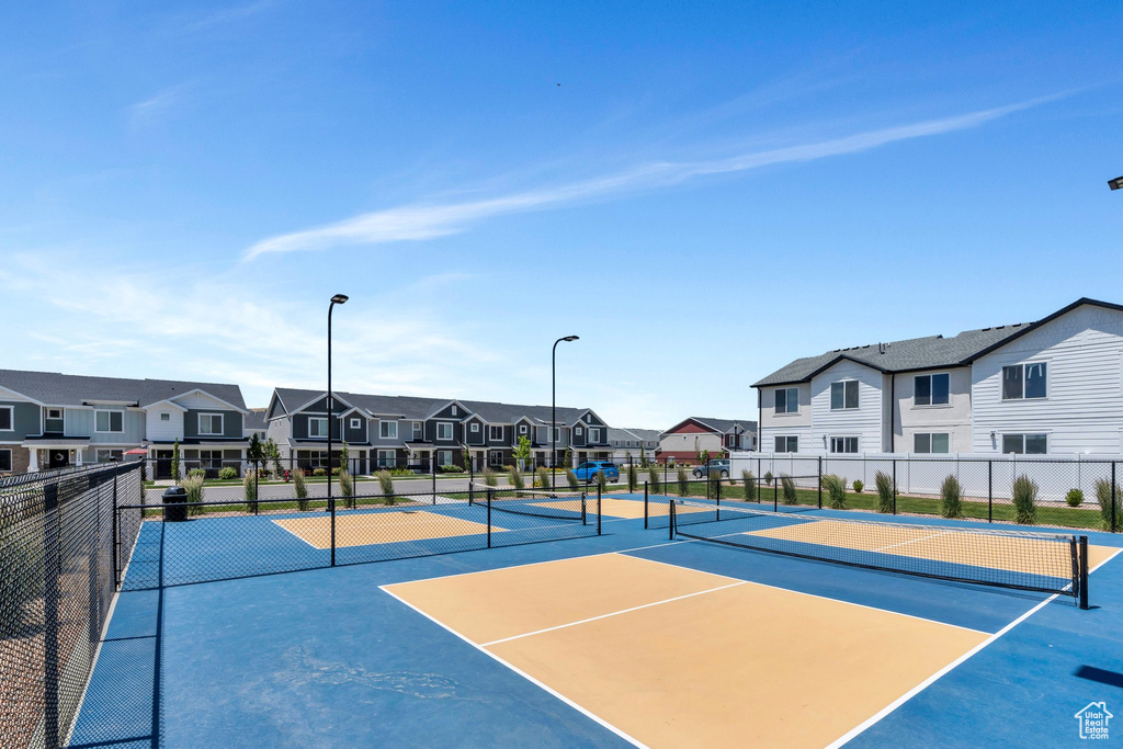 View of tennis court featuring a residential view