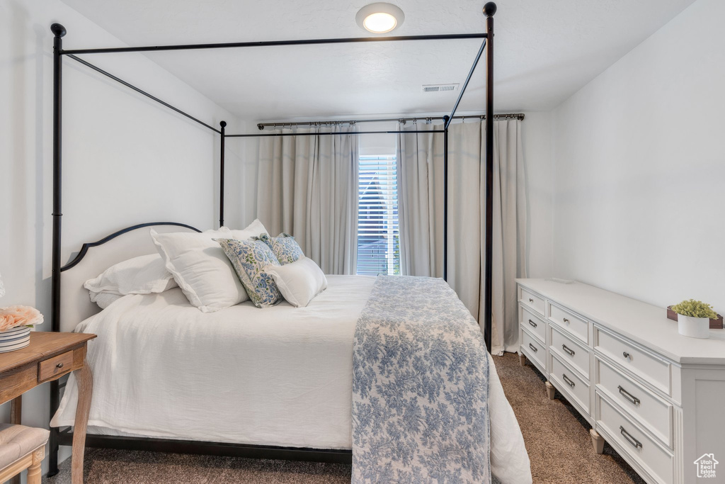 Bedroom featuring dark colored carpet
