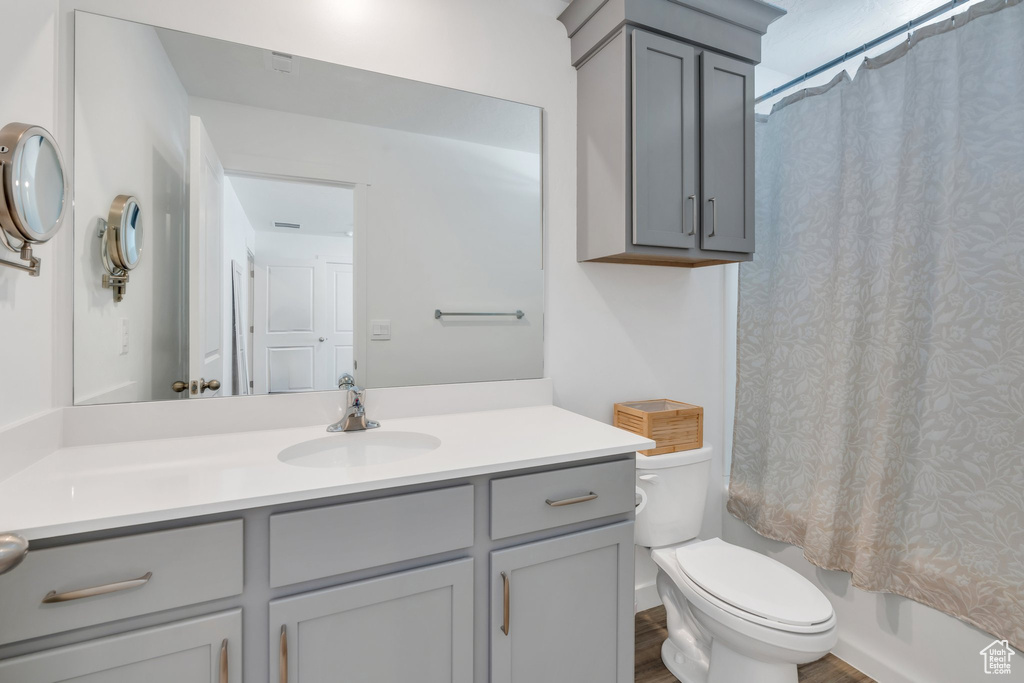 Bathroom featuring vanity and shower / bath combo with shower curtain