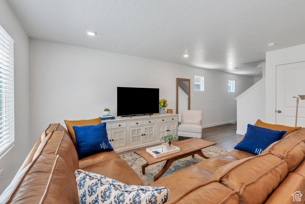 Living area with light wood-style floors, plenty of natural light, and recessed lighting